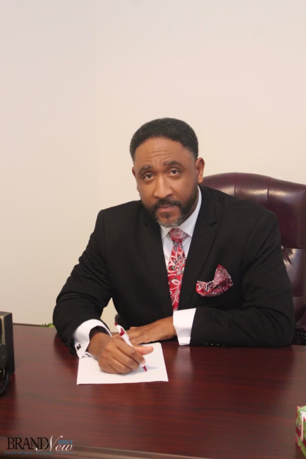 Pastor Allen Barnes III seated at his desk